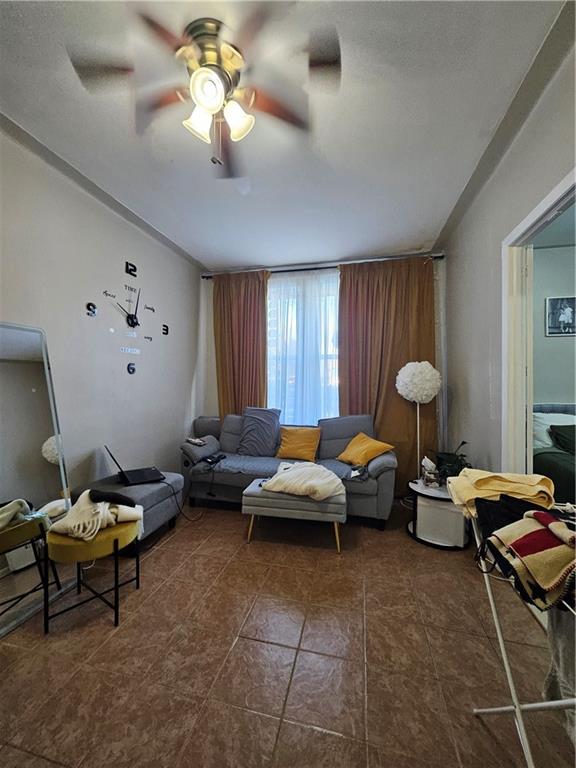 44 Quentin Road Brooklyn, NY 11223 - Photo 13 of 19 a living room with furniture and a chandelier