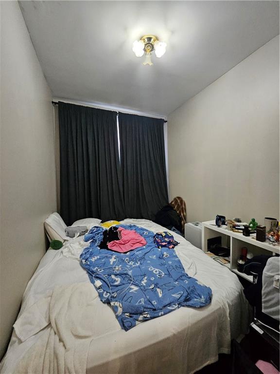 44 Quentin Road Brooklyn, NY 11223 - Photo 14 of 19 a bedroom with a bed and a table