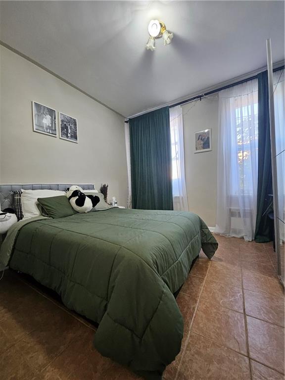 44 Quentin Road Brooklyn, NY 11223 - Photo 16 of 19 a bedroom with a bed and a window