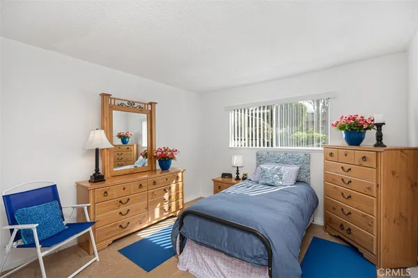 a bedroom with a bed and a dresser in it