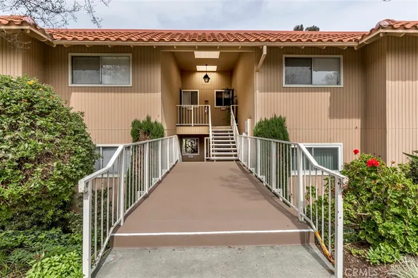 a view of a house with wooden fence