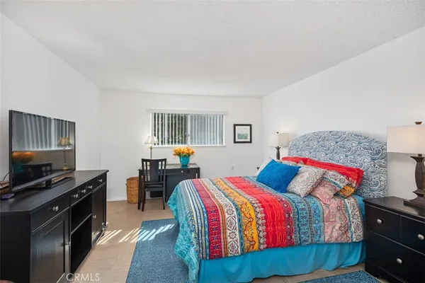 a bedroom with a bed and dresser