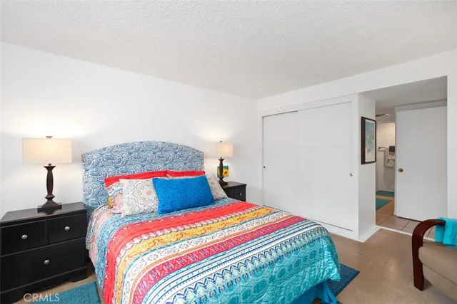 a bedroom with a bed and a lamp