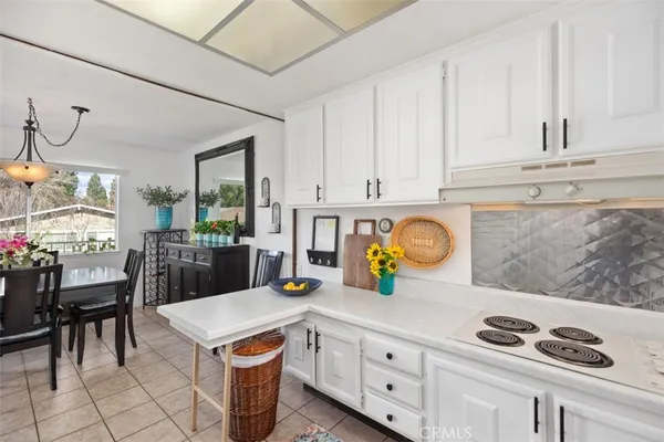 a kitchen with stainless steel appliances granite countertop a sink and a white cabinets