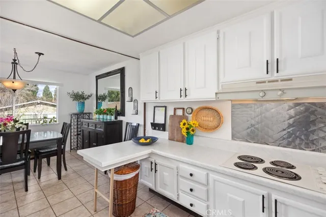 a kitchen with stainless steel appliances granite countertop a sink and a white cabinets