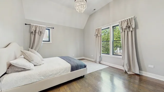 a bedroom with a bed and a large window