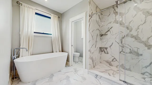 a bathroom with a bathtub and shower