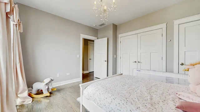 a bedroom with a bed and a chandelier