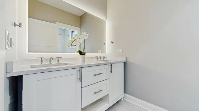 a bathroom with a granite countertop sink and a mirror