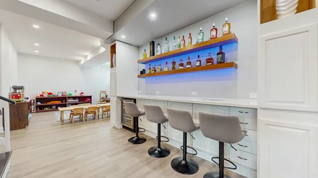 a living room with furniture and a book shelf