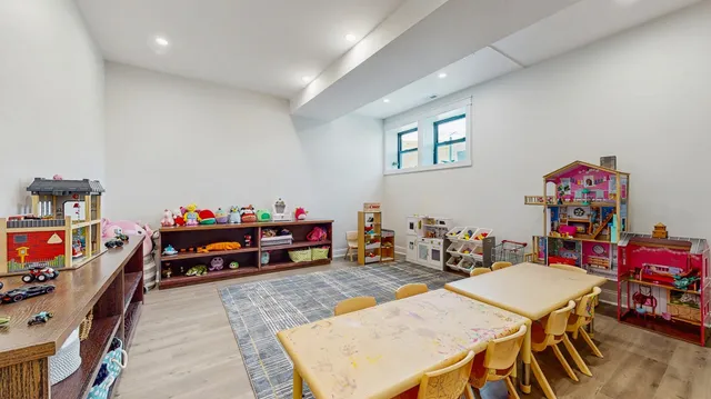 a children room with furniture and a flat screen tv