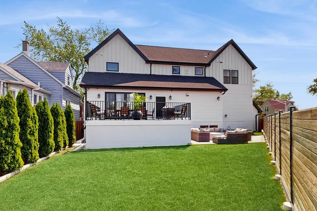 a front view of house with yard and outdoor seating