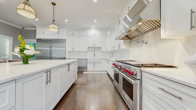 a kitchen with a white cabinets and stove