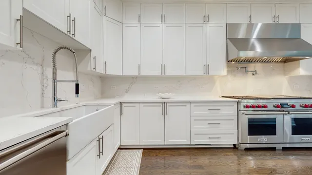 a kitchen with stainless steel appliances granite countertop a sink and a stove