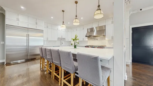a kitchen with kitchen island a counter top space appliances and cabinets