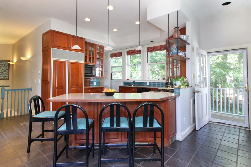 123 Buckminster Road Brookline, MA 02445 - Photo 12 of 28 a dining room with a table chairs and a chandelier