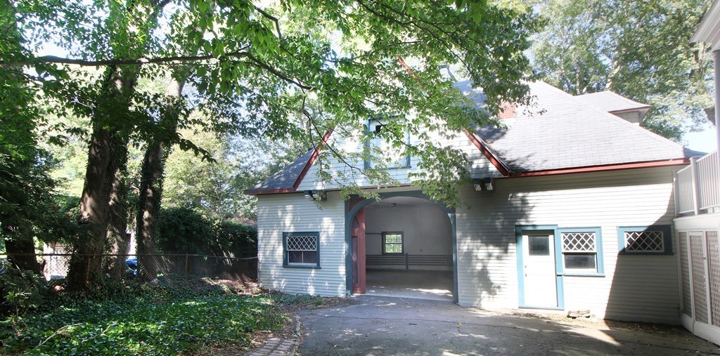 123 Buckminster Road Brookline, MA 02445 - Photo 26 of 28 a front view of a house with a garden