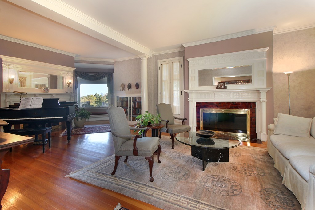 123 Buckminster Road Brookline, MA 02445 - Photo 3 of 28 a living room with furniture and a fireplace