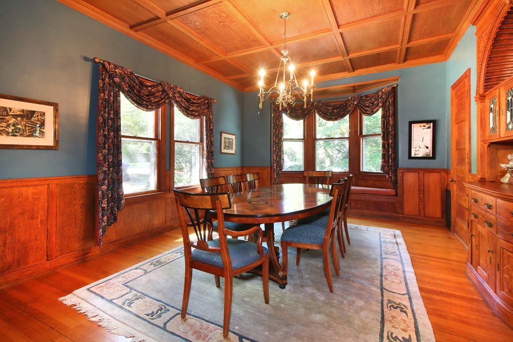 123 Buckminster Road Brookline, MA 02445 - Photo 6 of 28 a view of a dining room with furniture a chandelier and wooden floor