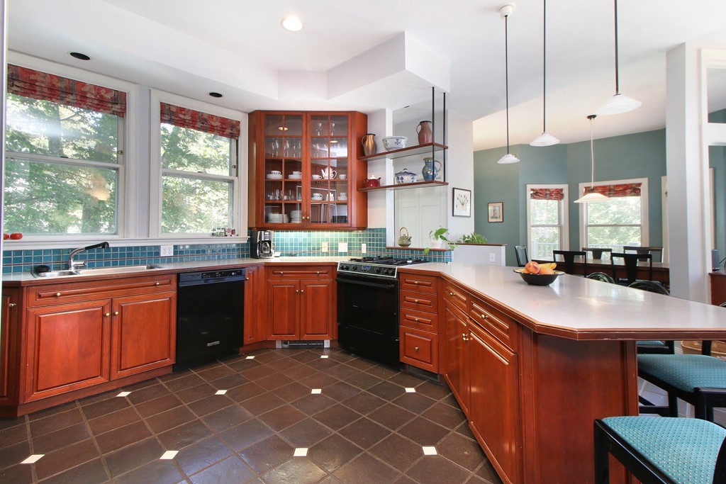 123 Buckminster Road Brookline, MA 02445 - Photo 8 of 28 a kitchen with granite countertop a sink stove and cabinets