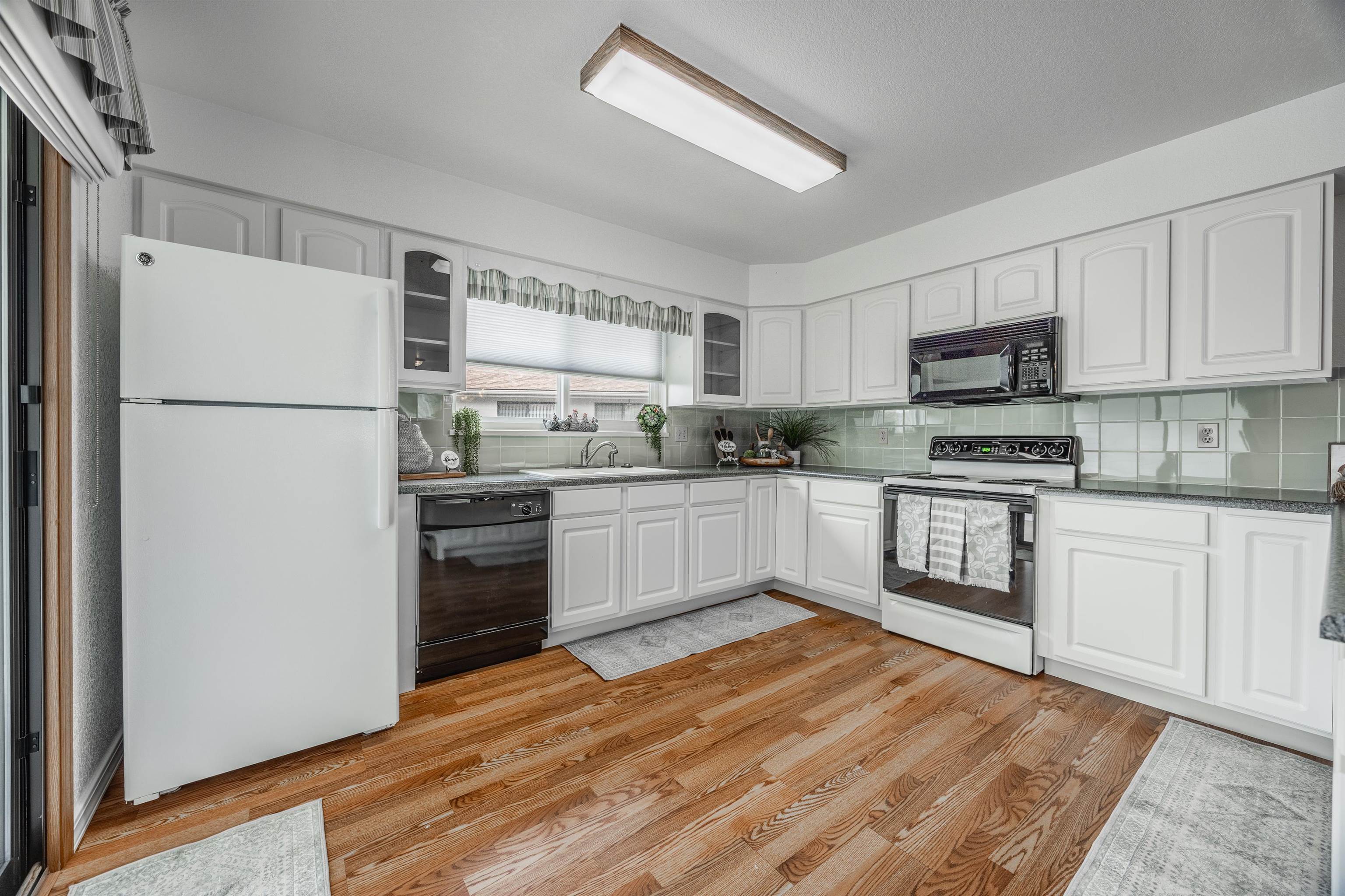 2135 Winston Way, Unit B Montrose, CO 81401 - Photo 11 of 25 a kitchen with a refrigerator a stove top oven a sink and cabinets