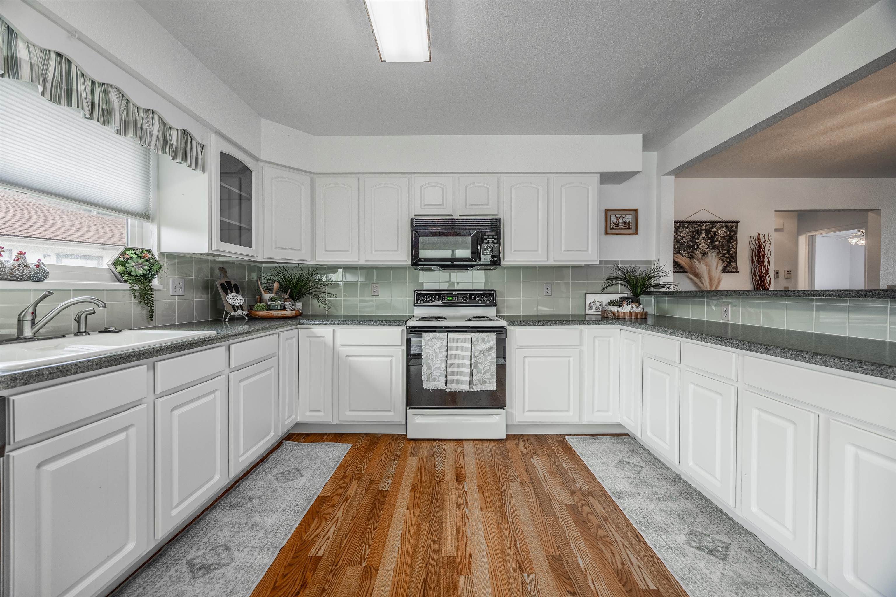 2135 Winston Way, Unit B Montrose, CO 81401 - Photo 12 of 25 a kitchen with granite countertop a refrigerator stove top oven and sink