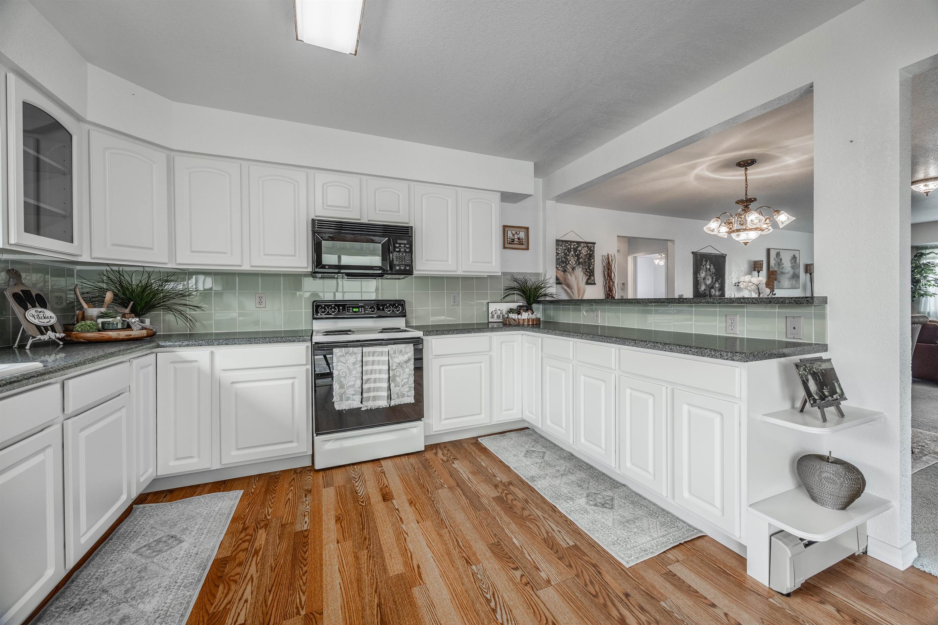 2135 Winston Way, Unit B Montrose, CO 81401 - Photo 13 of 25 a kitchen with granite countertop a sink cabinets and stainless steel appliances