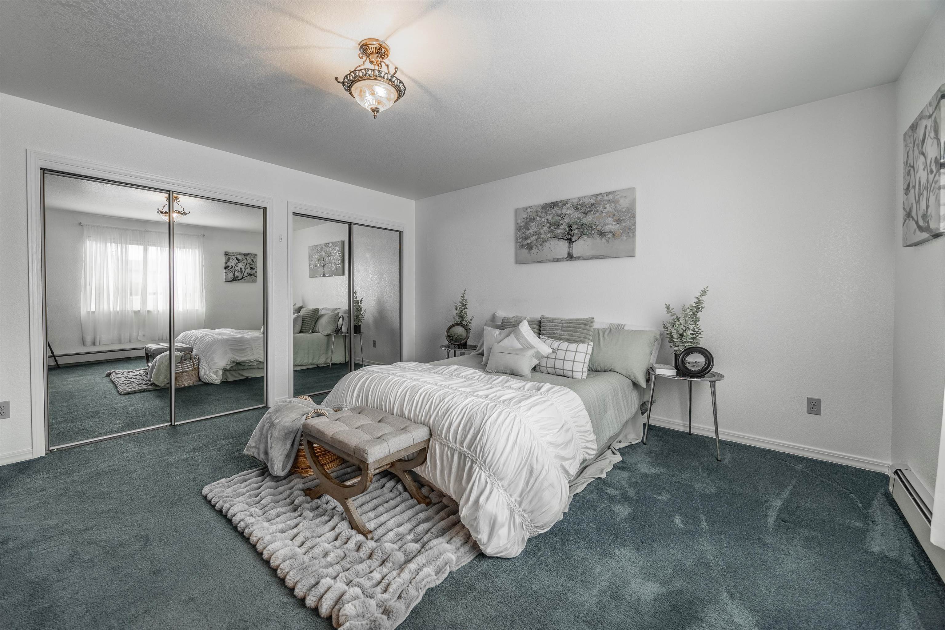 2135 Winston Way, Unit B Montrose, CO 81401 - Photo 17 of 25 a spacious bedroom with bed and a chandelier