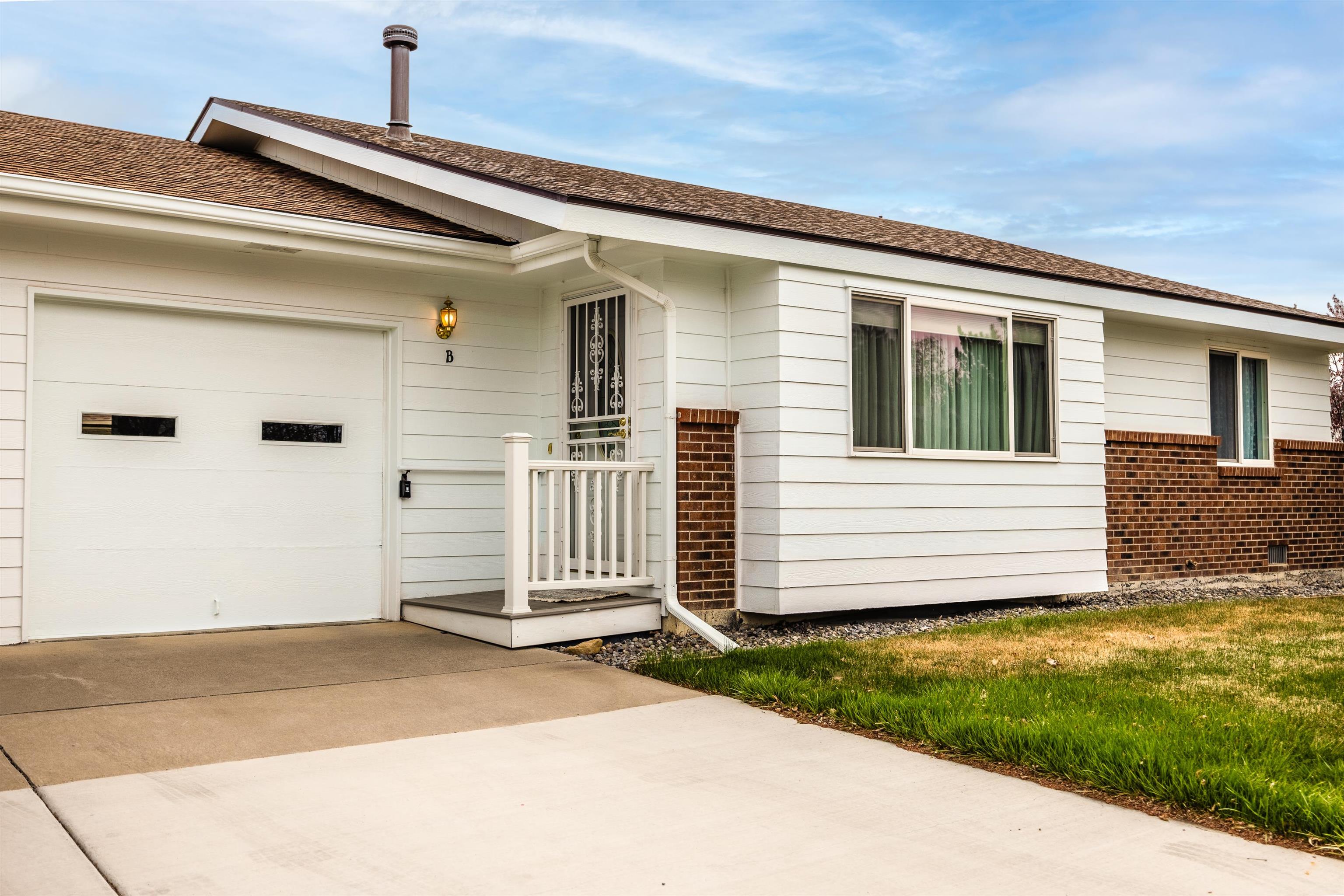2135 Winston Way, Unit B Montrose, CO 81401 - Photo 2 of 25 a front view of a house with a yard