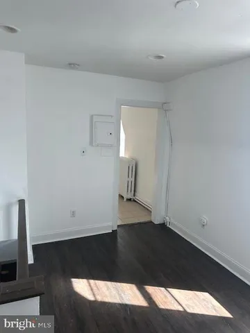 a view of an empty room and wooden floor