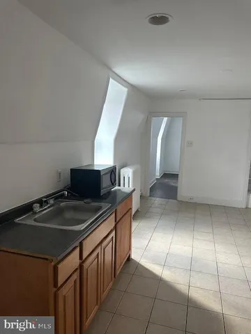 a kitchen with a sink a counter top space and cabinets