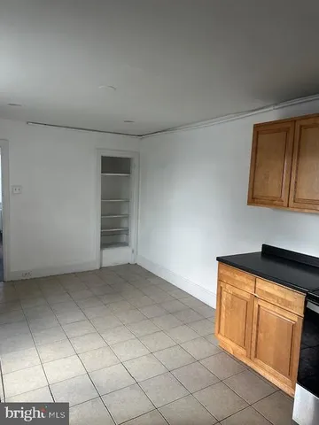 a view of a utility room with cabinets