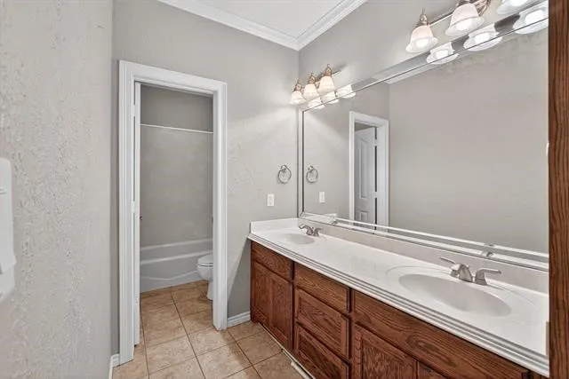 a spacious bathroom with a double vanity sink a large mirror and a shower