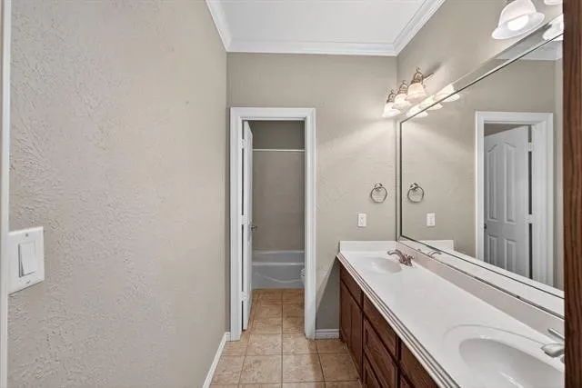 a bathroom with a double vanity sink a large mirror and a shower