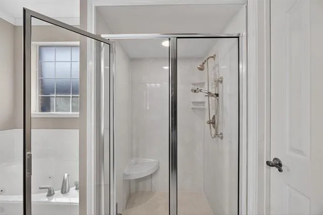 a bathroom that has a glass shower door