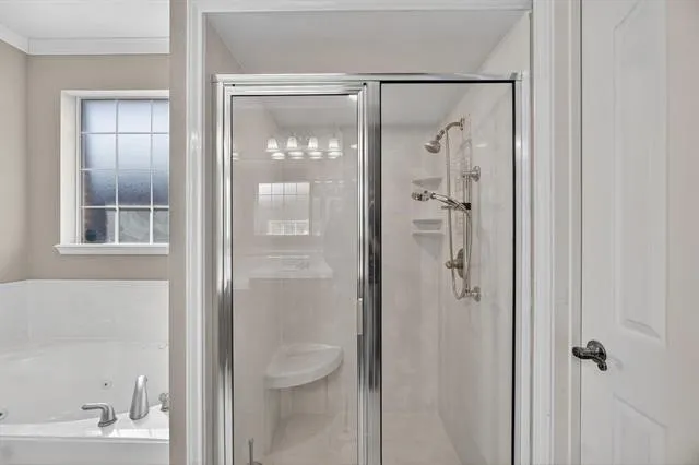 a bathroom with a shower and a sink