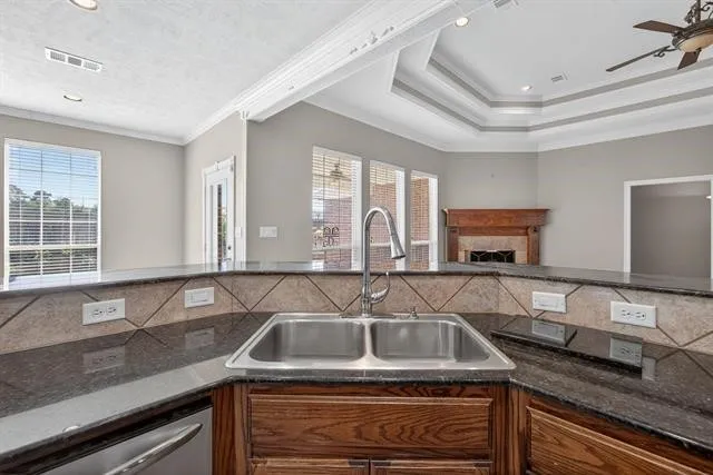 a kitchen with granite countertop a sink and a stove top oven