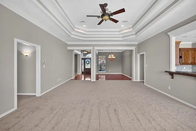 a view of a livingroom with a ceiling fan and window