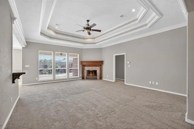 a view of an empty room with a fireplace and a window