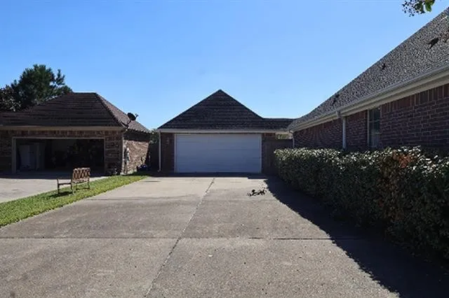 a front view of house with a yard and green space