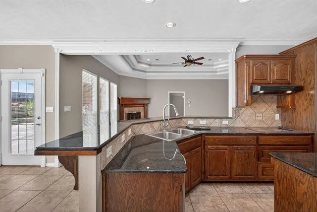 a kitchen with stainless steel appliances granite countertop a sink and a refrigerator