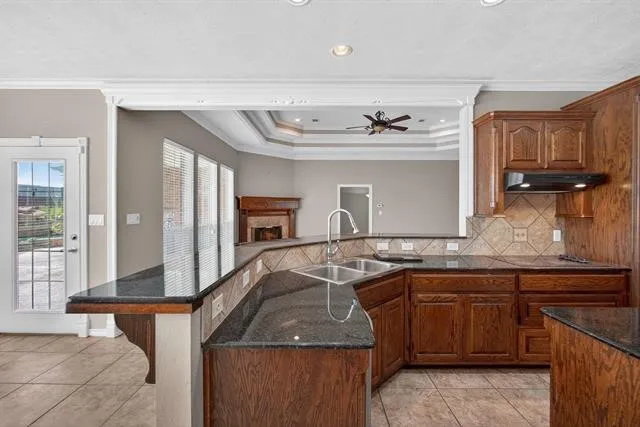 a kitchen with stainless steel appliances granite countertop a sink and a counter space