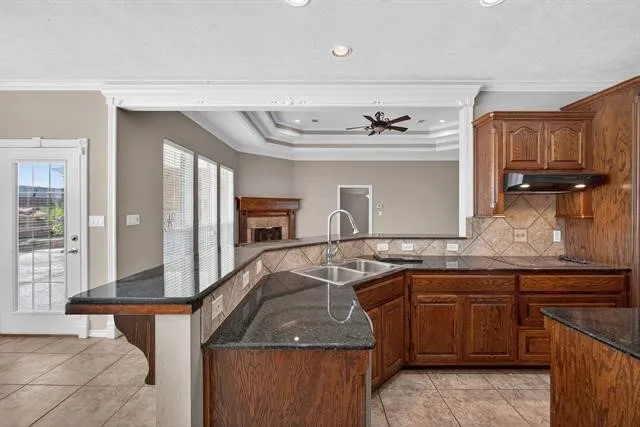 a kitchen with stainless steel appliances granite countertop a sink and a stove