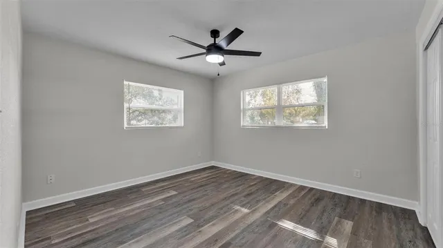 a view of empty room with wooden floor