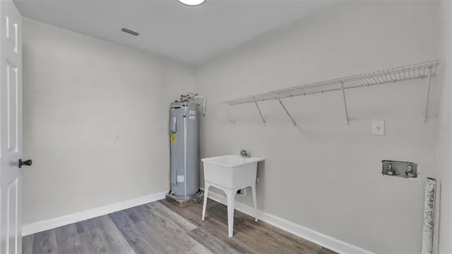 a view of a room with wooden floor and lounge chair