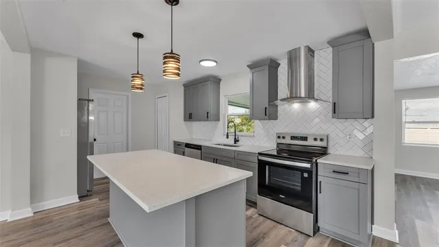 a kitchen with a stove a sink and a refrigerator