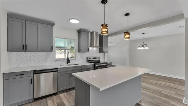 a kitchen with a sink a center island and cabinets
