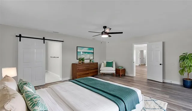 a bedroom with a bed and a chandelier