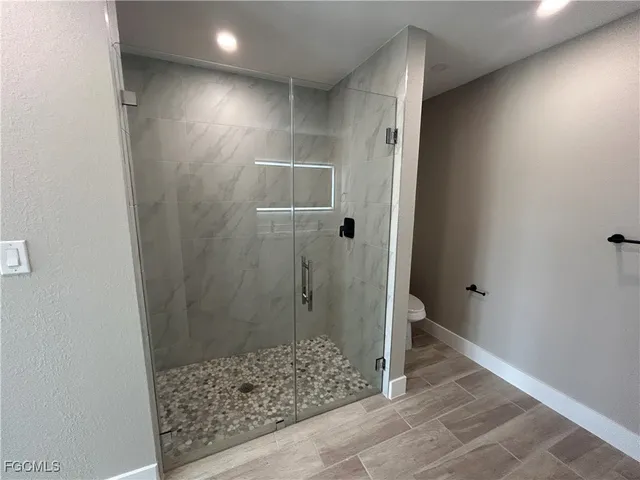 a bathroom with a shower and a sink
