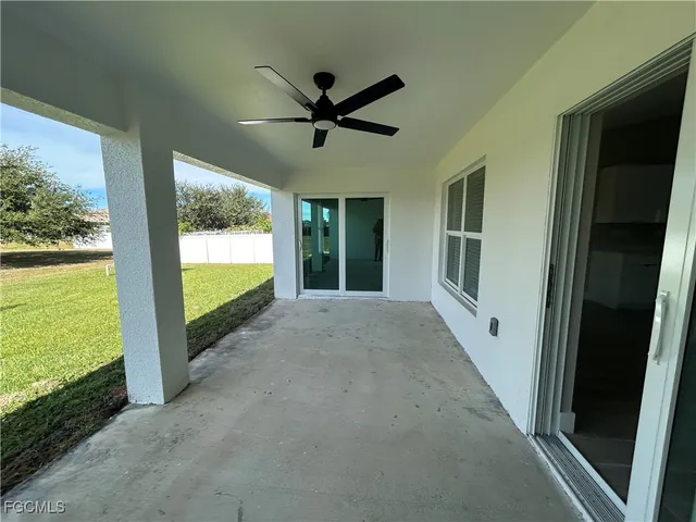 a view of a livingroom with a ceiling fan and a large window